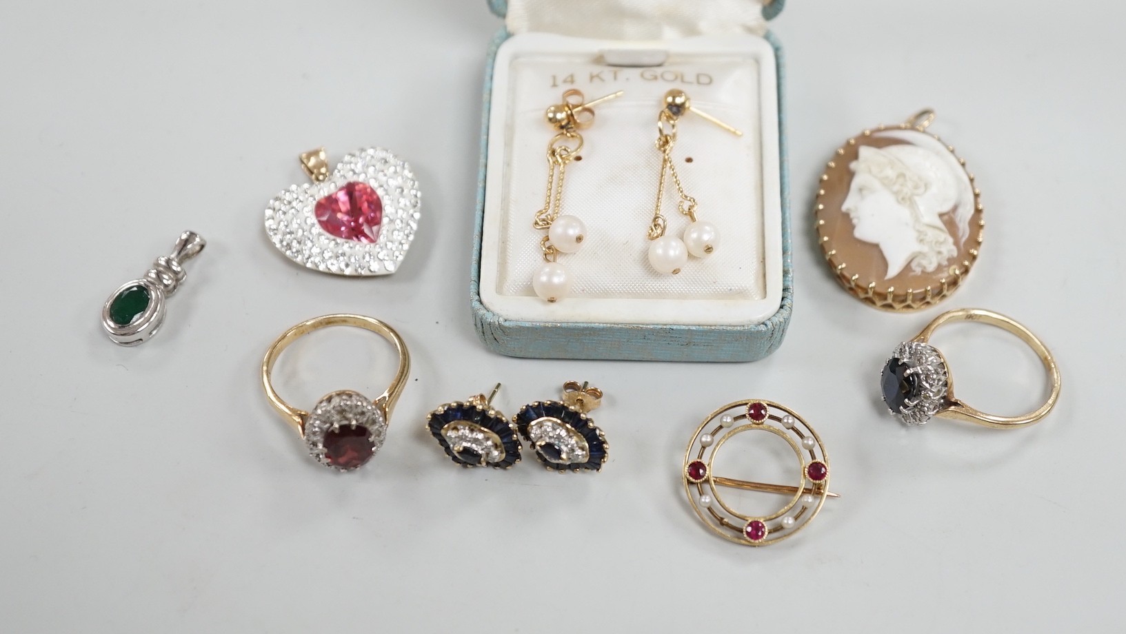 Mixed jewellery including two 9ct and gem set cluster rings and a 15ct, ruby and seed pearl set circular brooch, a yellow metal mounted oval cameo shell brooch, a pair of 9ct gold and gem set cluster ear studs, a 9ct whi